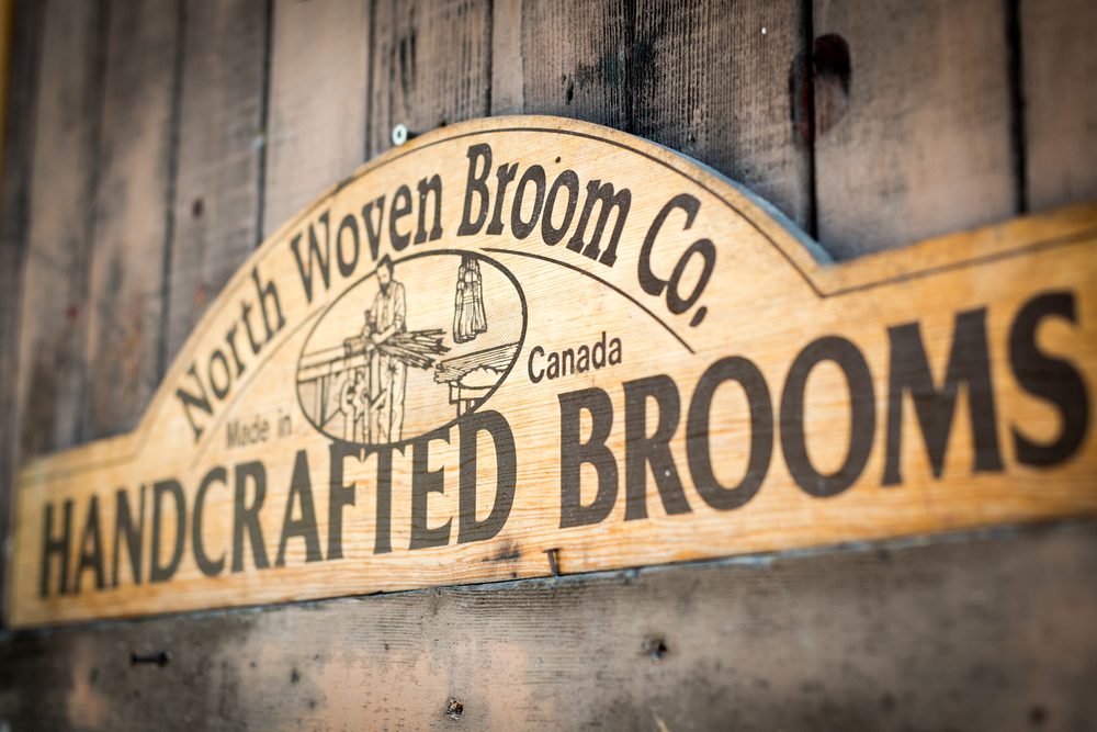 North Woven Broom Co. carved wooden sign